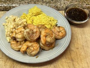 White Prawns served with yellow rice and side of homemade ginger sauce